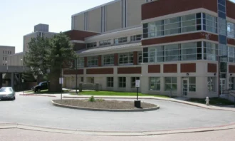 Roundabout in front of the entrance to a large brick and cement building