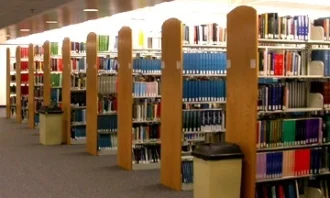 Eight rows of library shelves that are six books in height