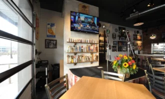 A stage with teo microphones and a wall of beertaps on display behind