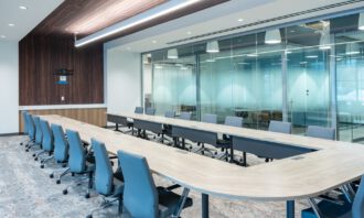 Large modern conference room with glass walls and collaborative seating