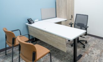Private office with desk, chairs, and storage cabinet