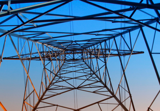 Looking up an electrical tower from underneath