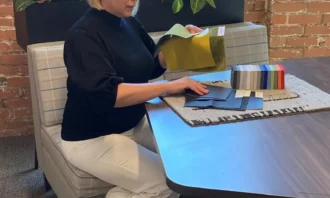 woman at desk with colorful design materials