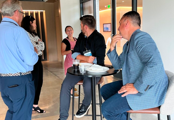 e4b colleagues talking together in an office common area