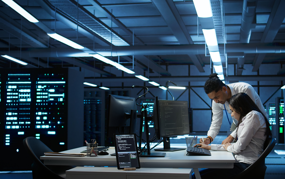 Two people at a data center having a meeting