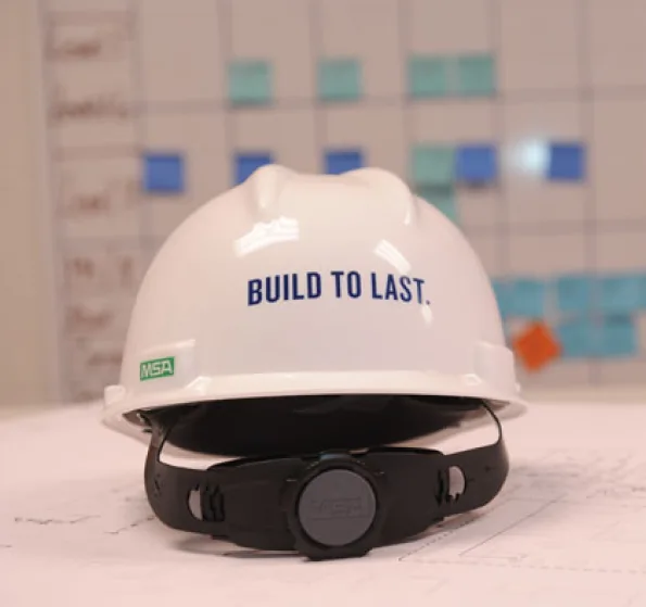 A hard hat with text that says "BUILT TO LAST."